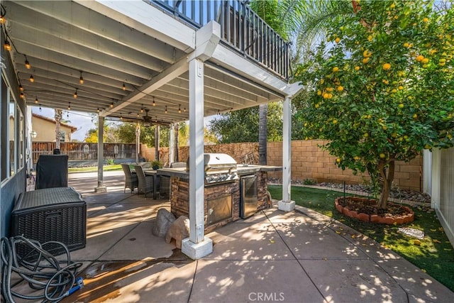 view of patio / terrace featuring ceiling fan, an outdoor kitchen, a balcony, and a grill