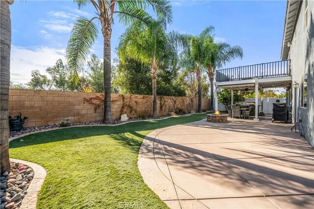 view of yard with a fire pit and a patio