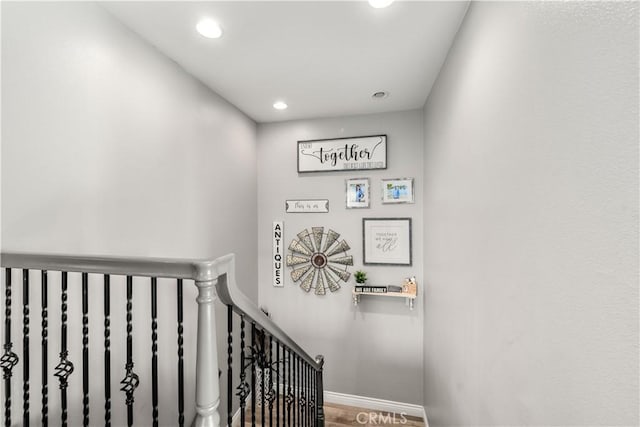 stairs featuring hardwood / wood-style floors