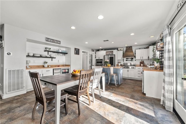 dining space featuring indoor bar and beverage cooler