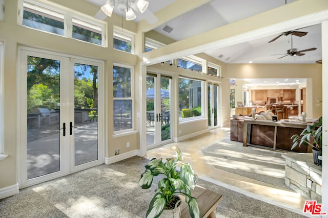 sunroom / solarium featuring french doors and vaulted ceiling with beams