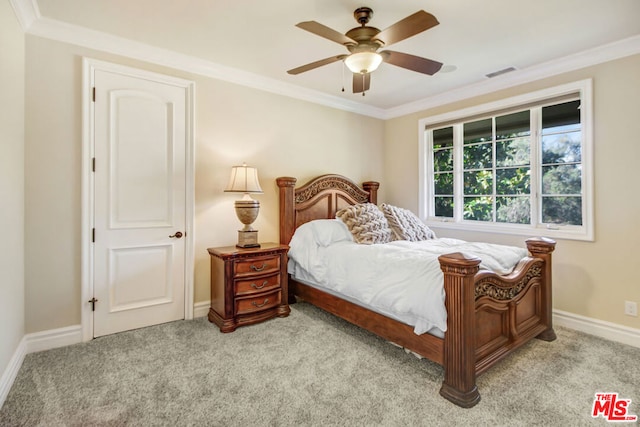 carpeted bedroom featuring ceiling fan and crown molding