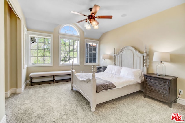 bedroom with ceiling fan, light colored carpet, a closet, and lofted ceiling