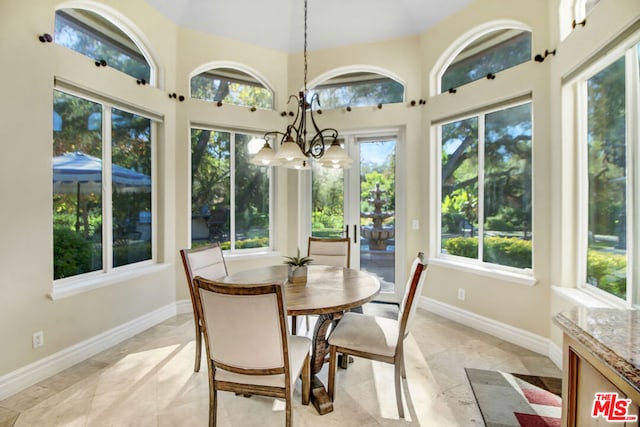 sunroom / solarium featuring a wealth of natural light and a notable chandelier