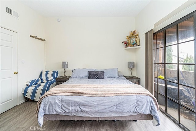 bedroom with hardwood / wood-style floors