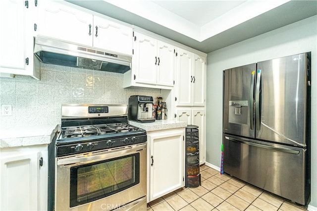 kitchen featuring stainless steel appliances, white cabinetry, light tile patterned flooring, and decorative backsplash