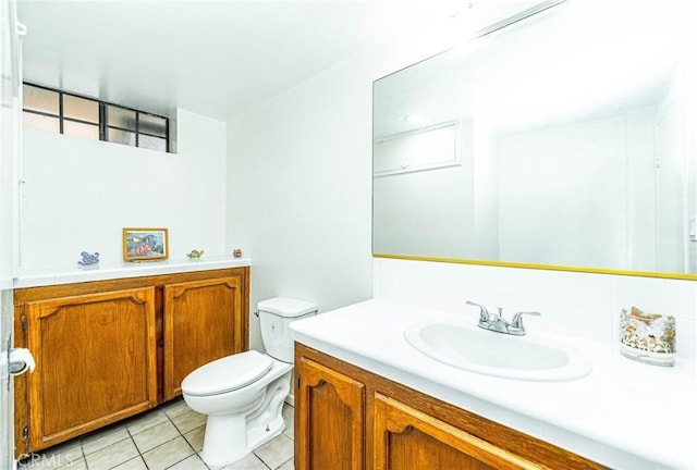 bathroom featuring vanity, toilet, and tile patterned flooring