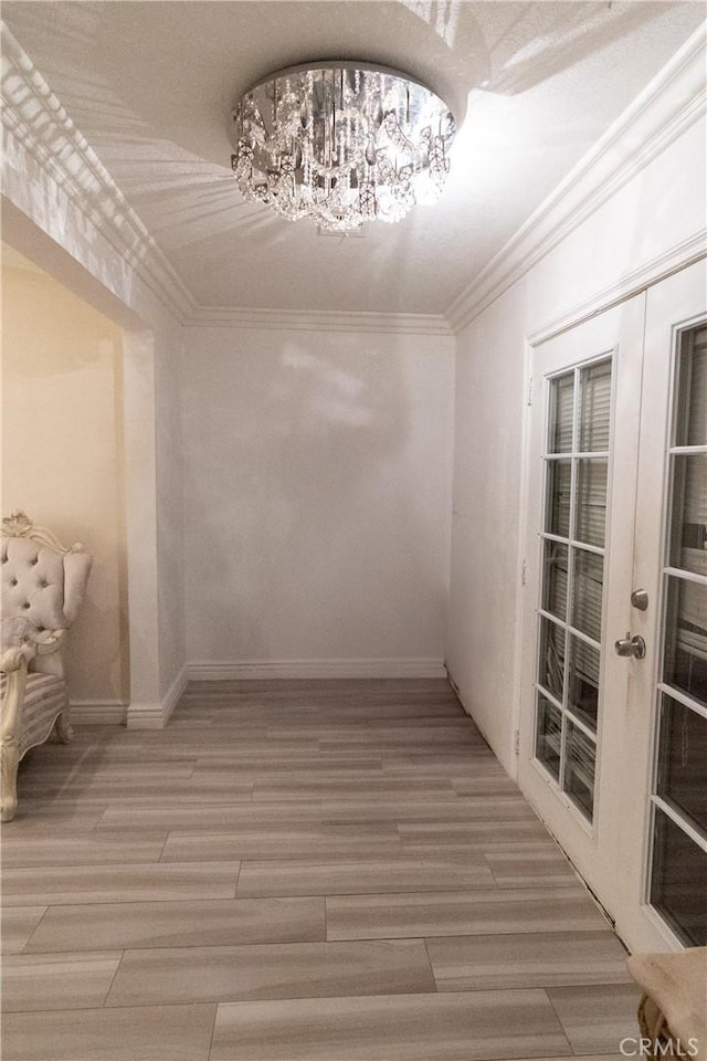 spacious closet with french doors, a chandelier, and hardwood / wood-style flooring