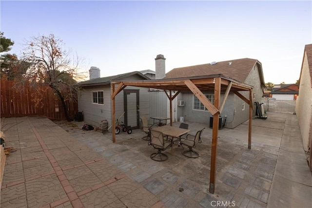 back house at dusk with a patio