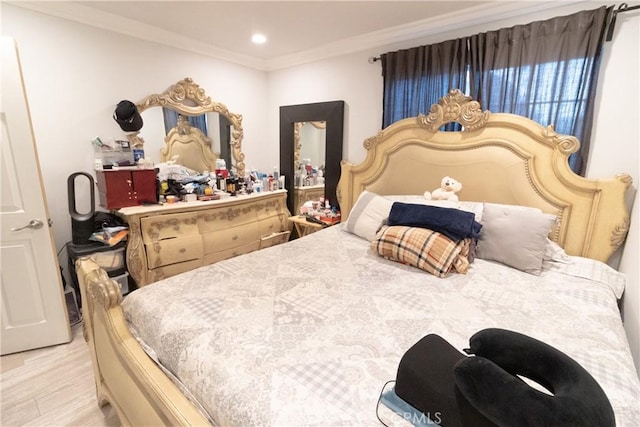 bedroom featuring crown molding and light hardwood / wood-style floors