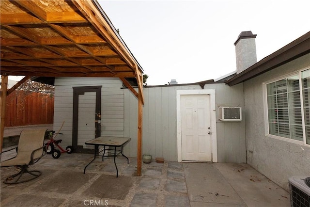 view of patio / terrace featuring an AC wall unit