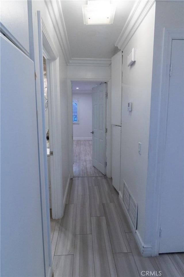 hall featuring crown molding and hardwood / wood-style flooring