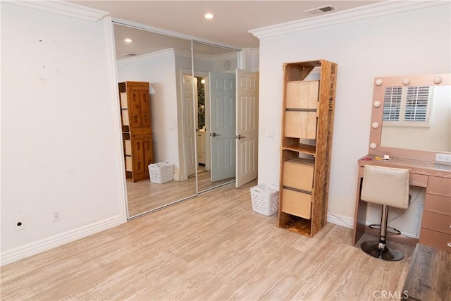 interior space featuring ornamental molding and light hardwood / wood-style flooring