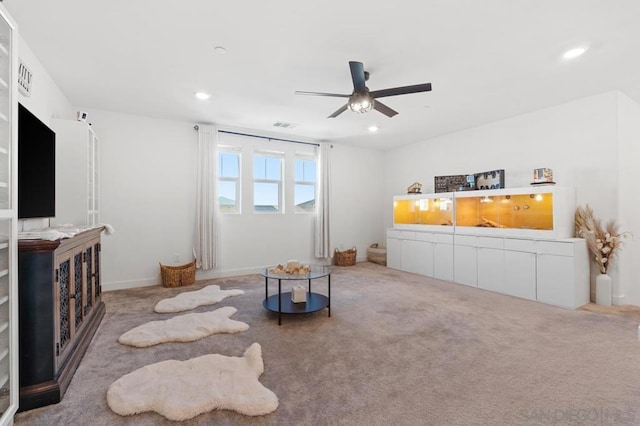 carpeted living room featuring ceiling fan