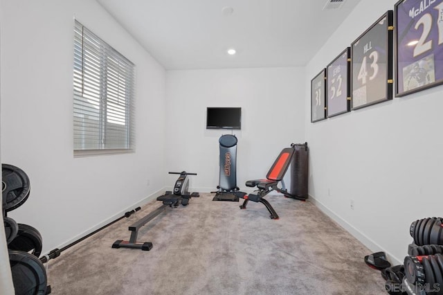 exercise area featuring light carpet