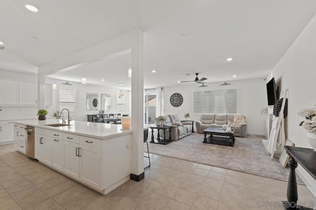 kitchen with dishwasher, white cabinetry, sink, ceiling fan, and light tile patterned floors