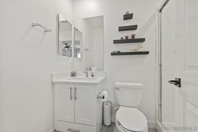 bathroom featuring toilet, vanity, and walk in shower