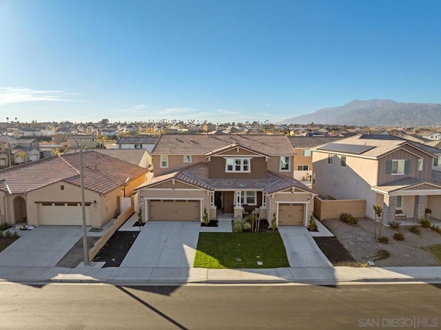 view of front of house with a garage and a mountain view