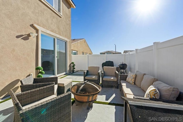 view of patio featuring an outdoor living space with a fire pit