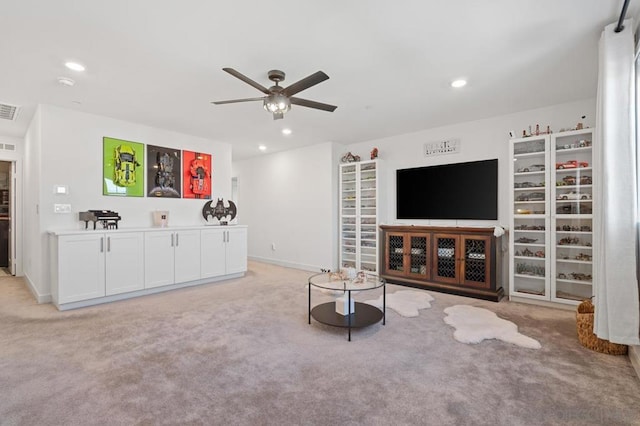 unfurnished living room with light carpet and ceiling fan