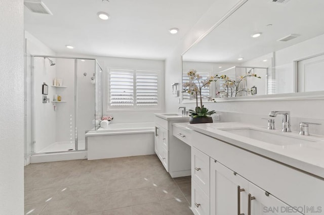 bathroom with tile patterned flooring, vanity, and shower with separate bathtub