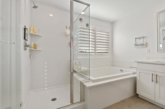 bathroom with vanity, independent shower and bath, and tile patterned flooring