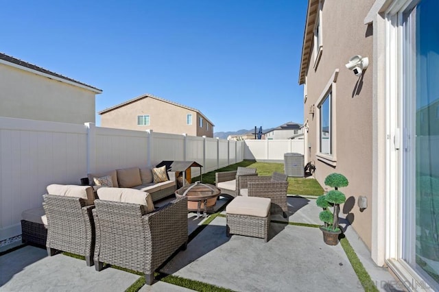 view of patio / terrace featuring an outdoor living space with a fire pit