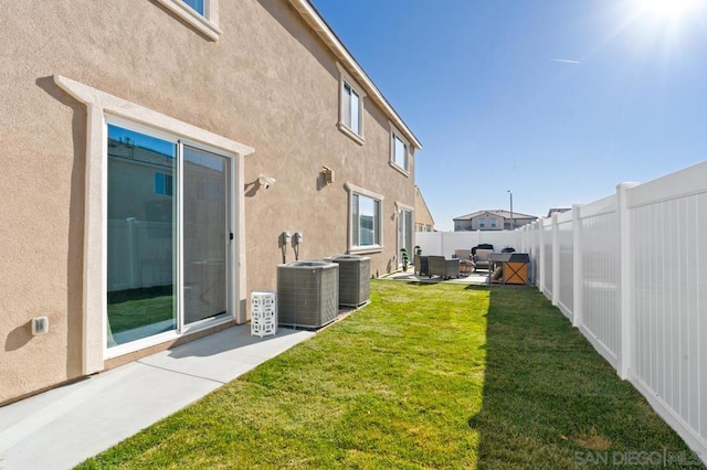 view of yard with a patio area and central AC