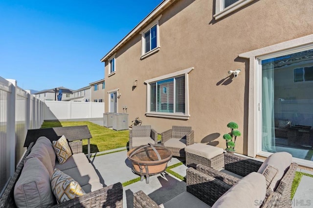 view of patio featuring an outdoor living space with a fire pit