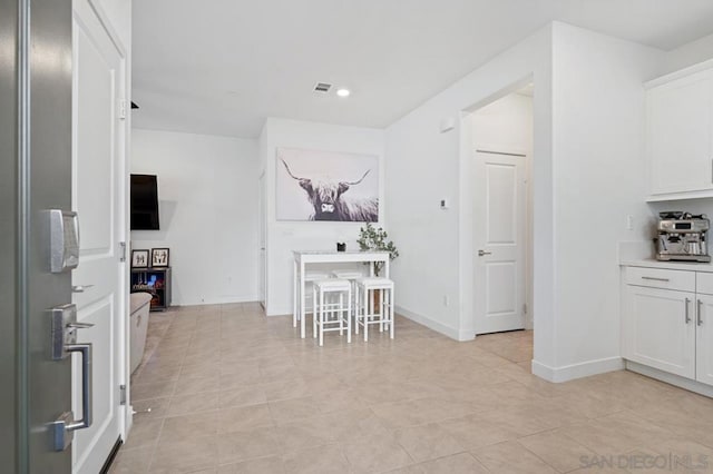 kitchen with white cabinetry and light tile patterned floors