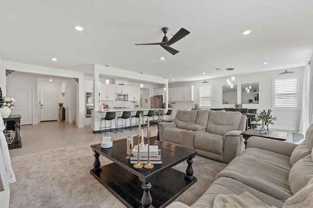 tiled living room featuring ceiling fan