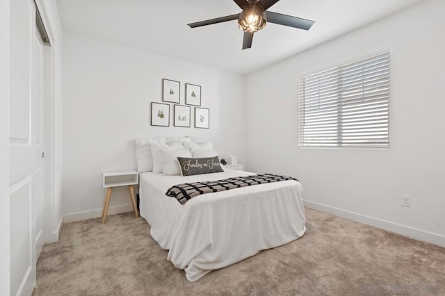 bedroom with ceiling fan, a closet, and light colored carpet