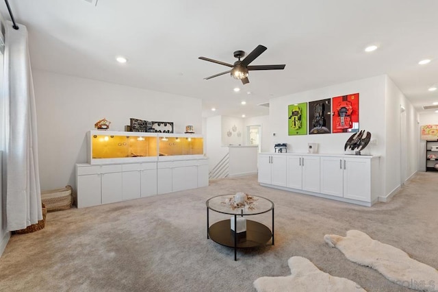 living room featuring ceiling fan and light colored carpet