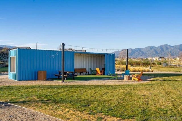 view of playground featuring a mountain view and a lawn