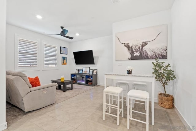 tiled living room with ceiling fan