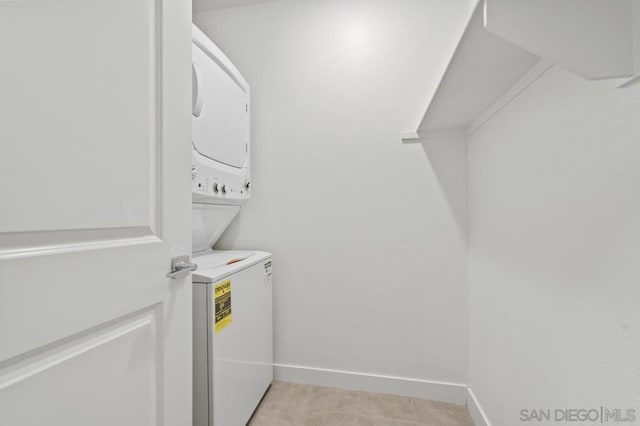 clothes washing area featuring stacked washer / dryer