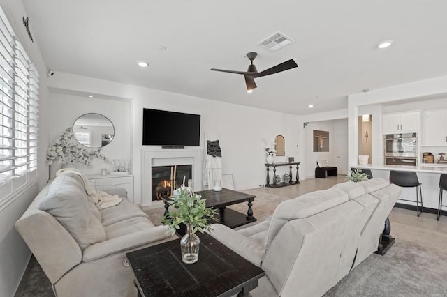 tiled living room featuring ceiling fan