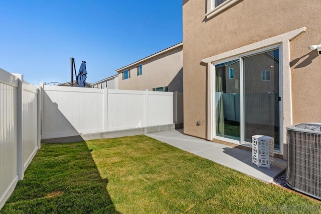 view of yard with central air condition unit and a patio area