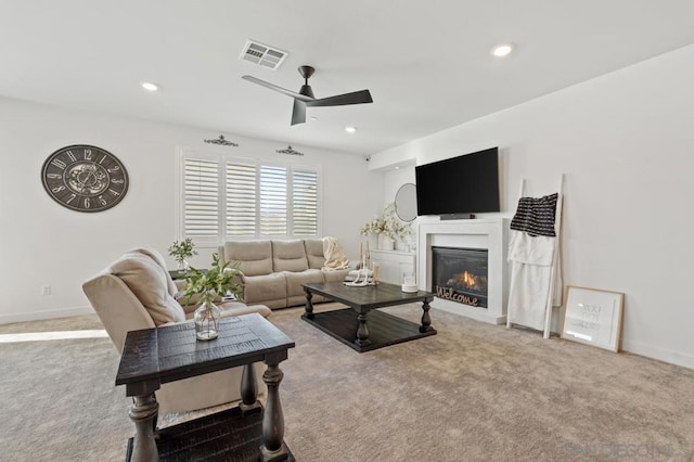 living room featuring ceiling fan and carpet flooring