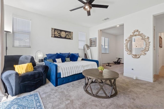 bedroom with ceiling fan and light colored carpet