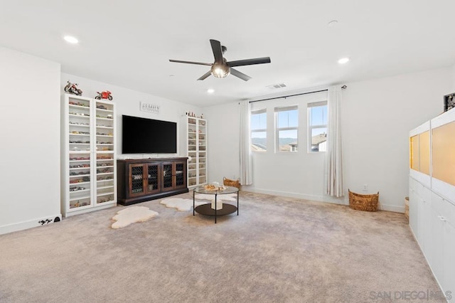 living room featuring ceiling fan and light colored carpet