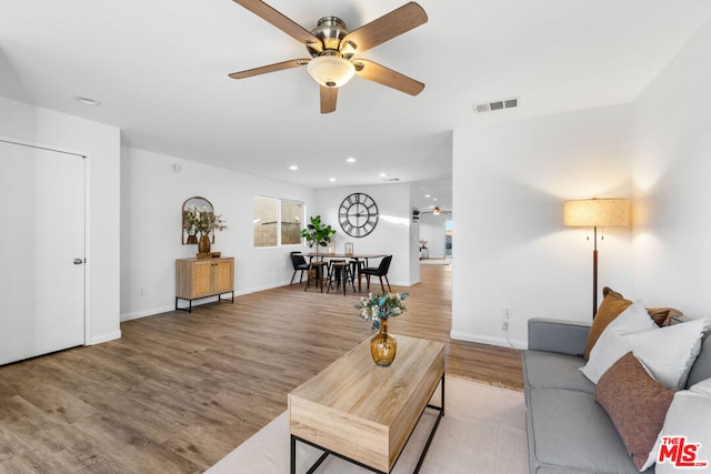 living room with ceiling fan and light hardwood / wood-style floors