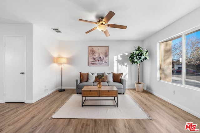 living room featuring ceiling fan, a healthy amount of sunlight, and light hardwood / wood-style flooring