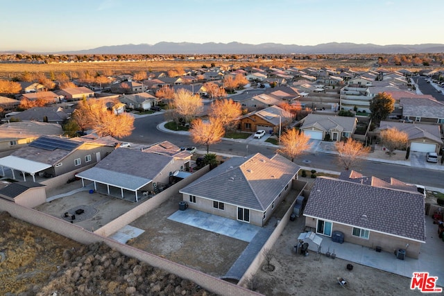 aerial view at dusk featuring a mountain view