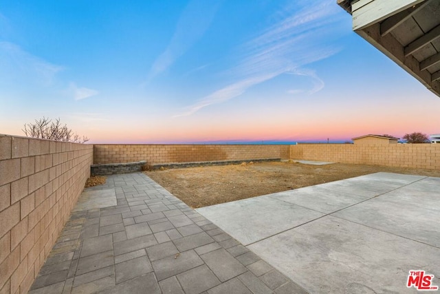 view of patio terrace at dusk