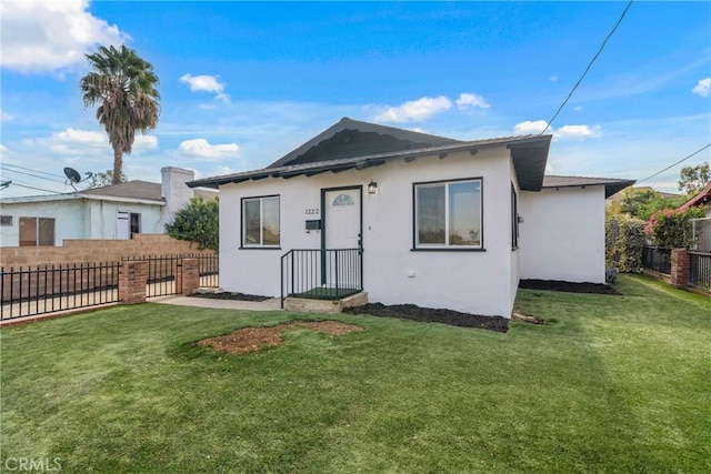 rear view of property featuring a yard