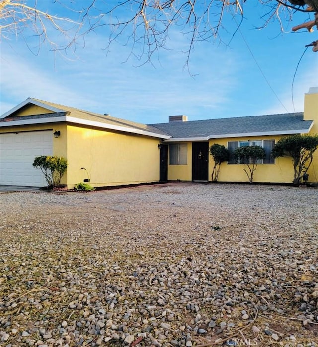 10907 Bartlett, Adelanto, CA 92301 - single story home featuring an attached garage, stucco siding, and gravel driveway