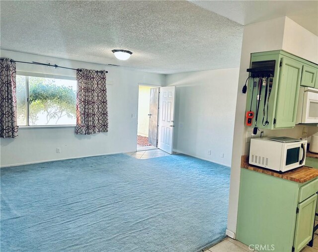 10907 Bartlett, Adelanto, CA 92301 - unfurnished room featuring light carpet, baseboards, and a textured ceiling