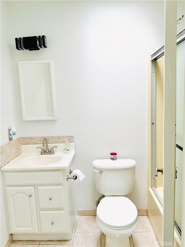10907 Bartlett, Adelanto, CA 92301 - bathroom with vanity, toilet, baseboards, tile patterned flooring, and bathtub / shower combination
