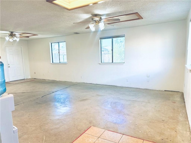 10907 Bartlett, Adelanto, CA 92301 - unfurnished room with a ceiling fan, a textured ceiling, and concrete flooring